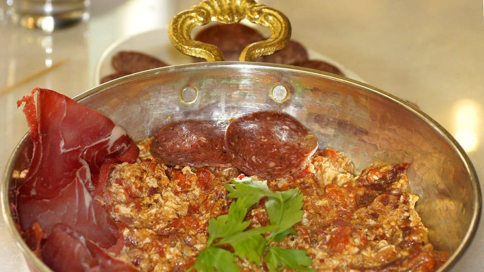 Karamanlidiko sachanaki with pastirma, eggs, soutzouki and tomato